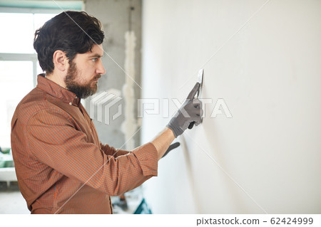 Bearded Man Renovating House 62424999