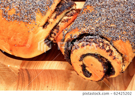 Fresh rolls with poppy seeds on a wooden surface, Fresh rolls with poppy seeds on a wooden surface, 62425202