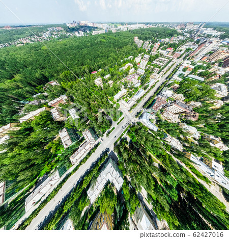 Aerial city view with crossroads and roads, houses, buildings, parks and parking lots. Sunny summer panoramic image 62427016