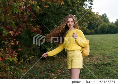 Cheerful smiling teenage girl of 14 years old with long curly red hair 62427874