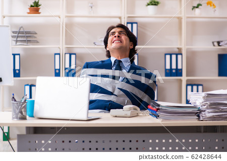 Young tied male employee in the office Young tied male employee in the office 62428644