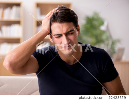Young handsome man suffering from pain Young handsome man suffering from pain 62428859
