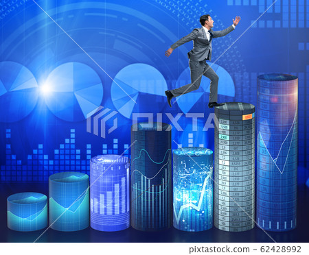 Businessman jumping over bar charts 62428992
