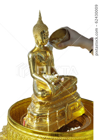 sprinkle water onto a Buddha image, isolated on white background. 62430009
