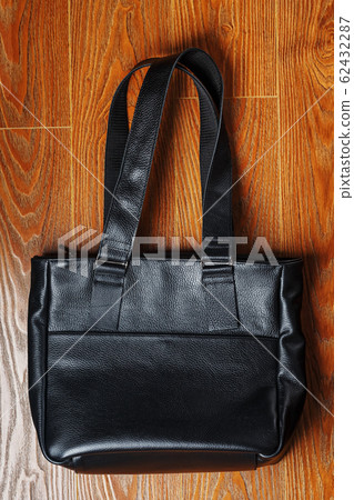 Powerbank charges a smartphone on a pink 62432287