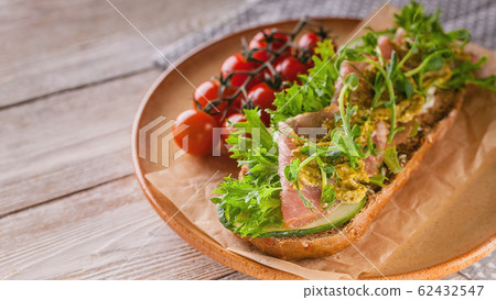 Close up bruschetta with raw smoked meat 62432547