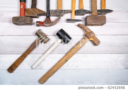 set of different types of old hammers on a wooden 62432698