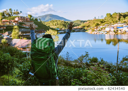 Tourists with backpack standing in a tea plantation watching the beautiful mountain 62434540