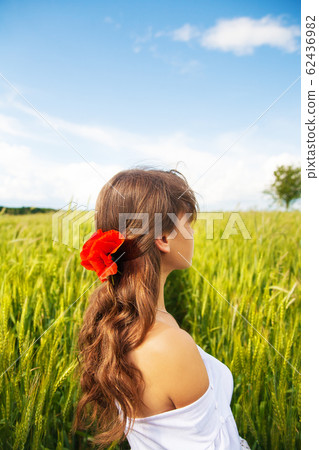 Beautiful girl is standing with her back in a Beautiful girl is standing with her back in a 62436982