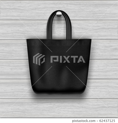 Textile textured black tote bag hanging on the wooden plank textured wall. Textile textured black tote bag hanging on the wooden plank textured wall. 62437125