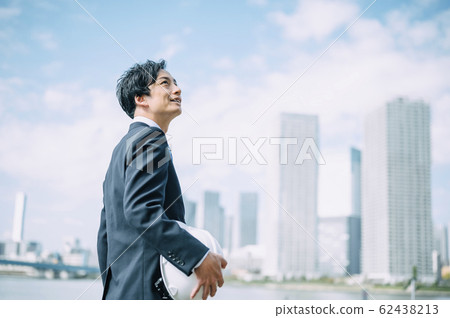 A businessman with a helmet A businessman with a helmet 62438213