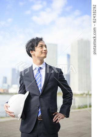 A businessman with a helmet A businessman with a helmet 62438292