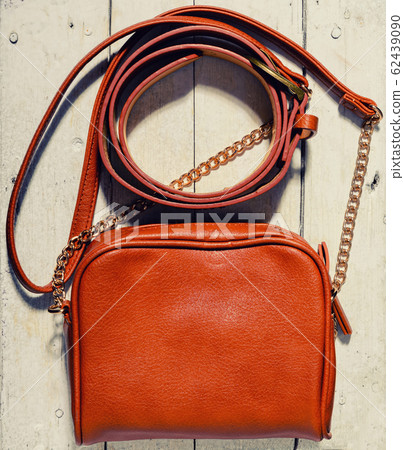 woman bag and belt on wooden background woman bag and belt on wooden background 62439090