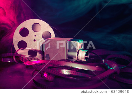 8 mm movie camera with a reel of film in green and 62439648
