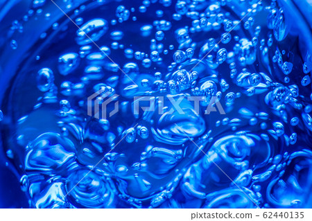 Liquid blue gel bubbles. Polymer gel. Silica gel. Balls of blue hydrogel. Crystal liquid ball with reflection. Texture background. Close up macro. Soapsuds background with air bubbles 62440135