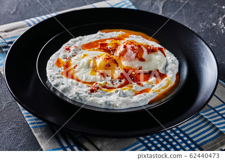 close-up of cilbir, poached eggs in yogurt sauce close-up of cilbir, poached eggs in yogurt sauce 62440473