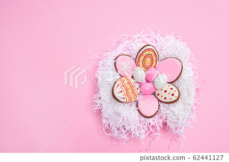 Decorative bird's nest filled with colorful Easter eggs 62441127