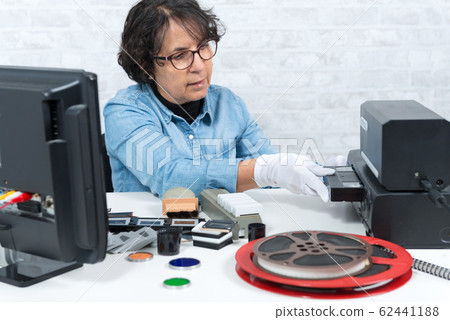 technician woman with VHS cassette for 62441188