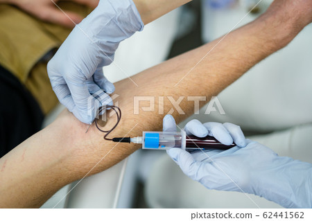 Blood sampling from a man in a test tube from a vein Blood sampling from a man in a test tube from a vein 62441562
