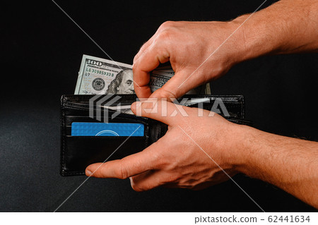 Man on black background holds in his hands a 62441634