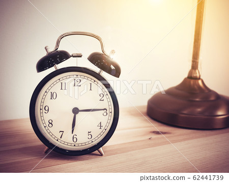 Closeup retro alarm clock on wooden table with copy space, retro style Closeup retro alarm clock on wooden table with copy space, retro style 62441739