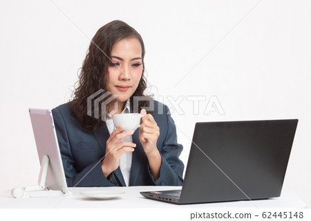 Beautiful young executive with her work and coffee Beautiful young executive with her work and coffee 62445148