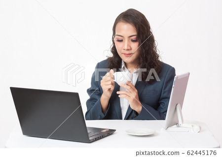 Beautiful young executive with her work and coffee Beautiful young executive with her work and coffee 62445176