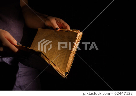 Woman's reading old holy bible. 62447122