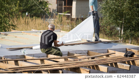 Workers cut the roof in the house 62448387
