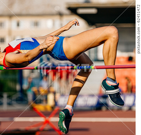 women athlete jumping high jump 62451472