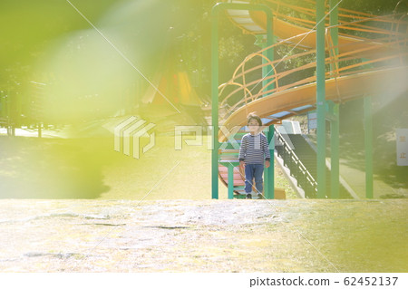 Boy standing in the park 62452137