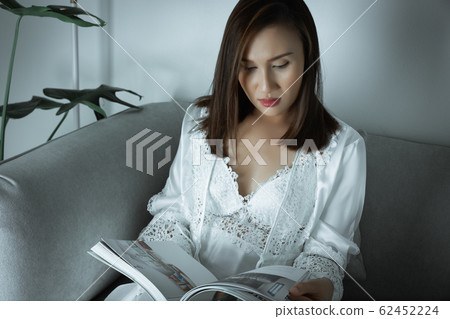 Women reading the magazine article. Women reading the magazine article. 62452224