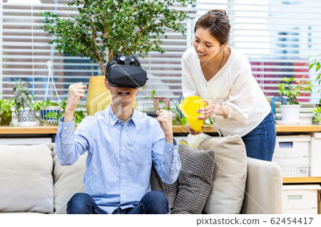 Couple watching sports in VR Couple watching sports in VR 62454417