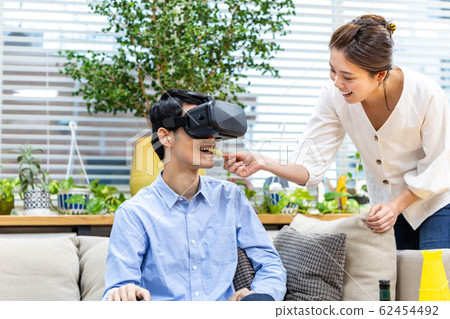 Couple watching sports in VR Couple watching sports in VR 62454492