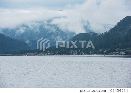 Foggy Teletskoye lake in Altai mountains Foggy Teletskoye lake in Altai mountains 62454934