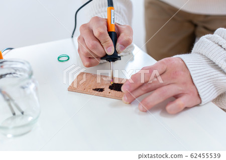 Wood burning man 62455539