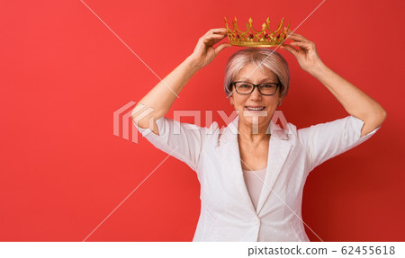 senior woman posing on red background 62455618