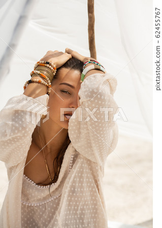 Woman Resting on the Beach During Vacation Woman Resting on the Beach During Vacation 62455767
