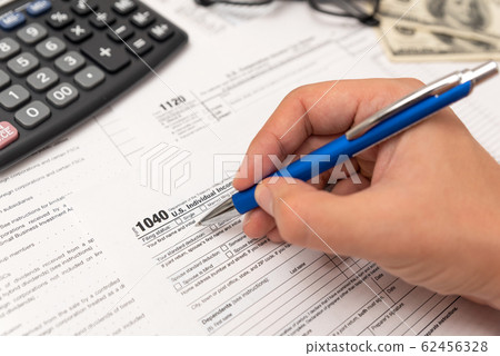 Man filling US tax form in office 62456328