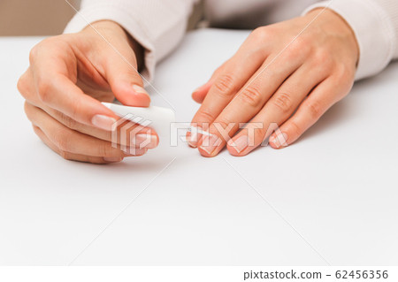 closeup beautiful female hands painting nails with protective polish closeup beautiful female hands painting nails with protective polish 62456356