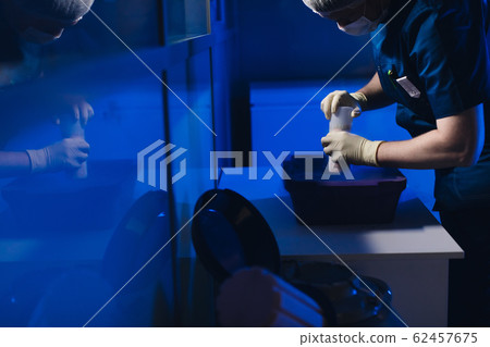 Specialist Embryologist Takes a capsule With Embryos from the Cryobank Specialist Embryologist Takes a capsule With Embryos from the Cryobank 62457675