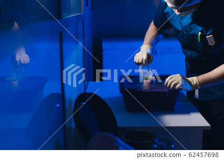 Specialist Embryologist Takes a capsule With Embryos from the Cryobank Specialist Embryologist Takes a capsule With Embryos from the Cryobank 62457698