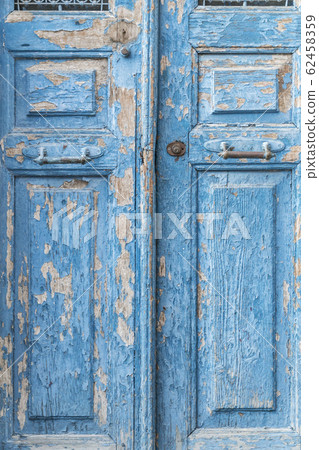 a blue wooden door is a peeling color a blue wooden door is a peeling color 62458359