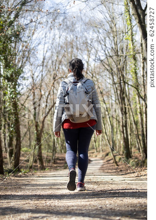 Pretty woman walking in the beech forest at Pretty woman walking in the beech forest at 62458727