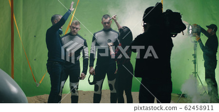 Director watching a shooting and discussing with an actor Director watching a shooting and discussing with an actor 62458911