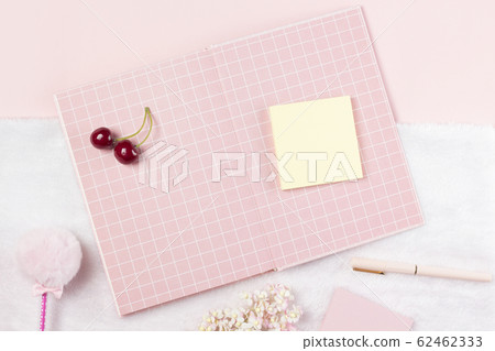flat lay stationery on work desk in pink pastel background 62462333