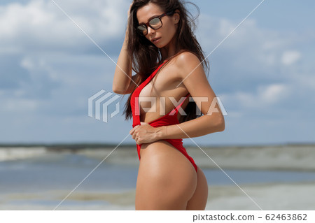 Beautiful woman in swimsuit on beach 62463862
