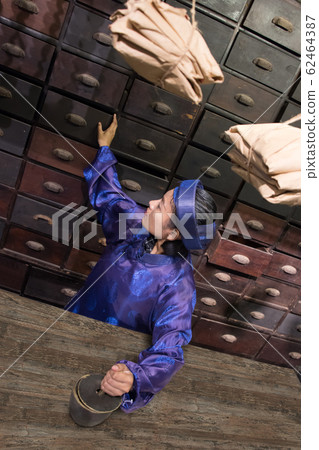 Asian pharmacist working at oriental pharmacy from Asian pharmacist working at oriental pharmacy from 62464387