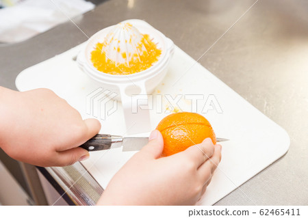 Children's hand making fresh juice Children's hand making fresh juice 62465411