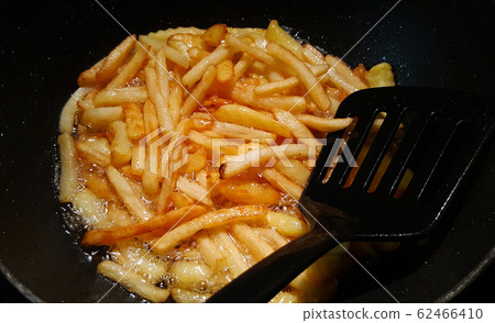 creative photo of french fries fried in a black pan 62466410